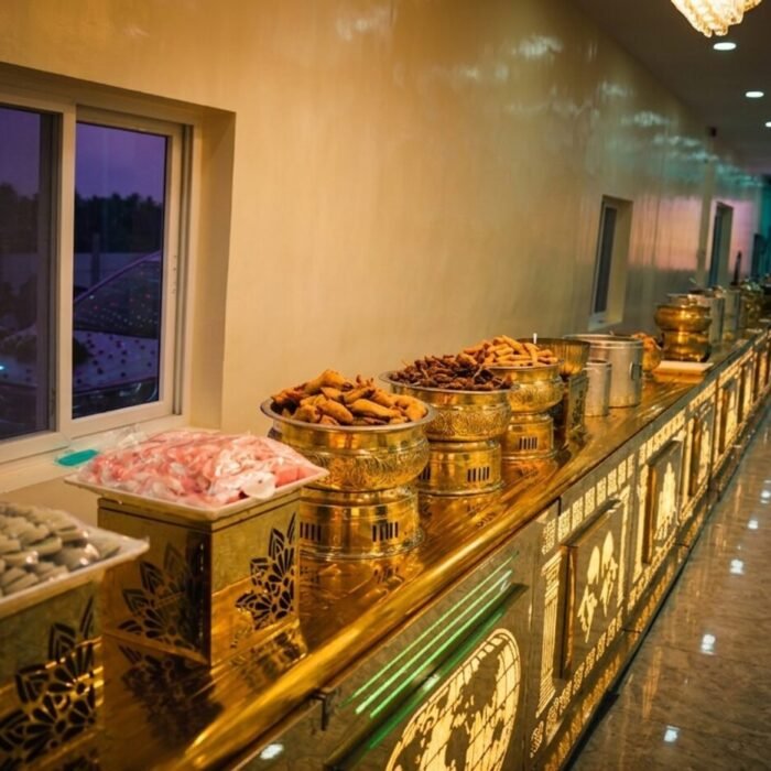Decorative gold live-counter setup at dusk, Sri Sai Manikanta Caterers